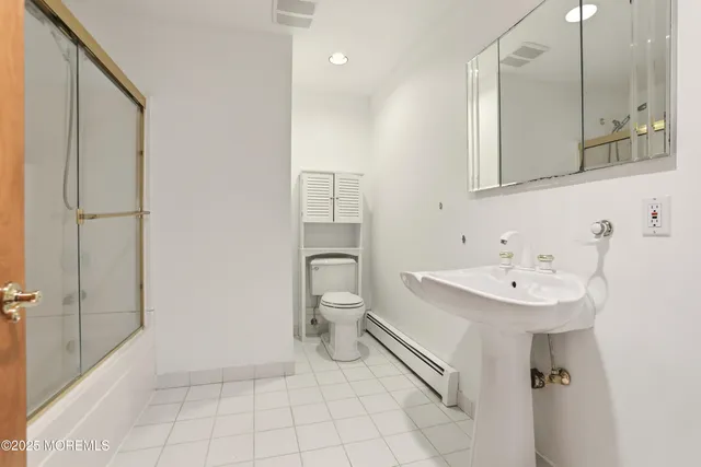 an empty room with wooden floor ceiling fan and windows