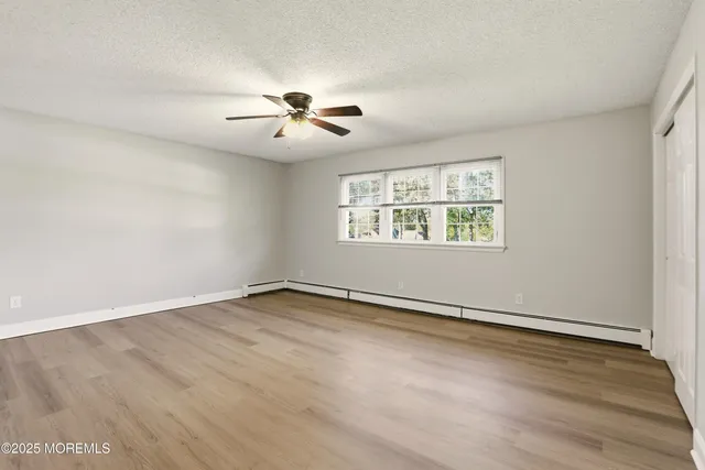 a bathroom with a granite countertop toilet sink and mirror
