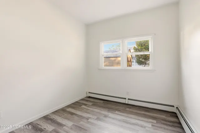 a view of an empty room with a fireplace and a window