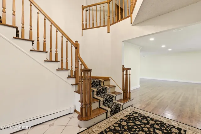 a view of a livingroom with wooden floor and stairs