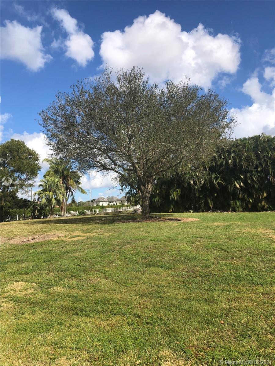 13240 Stirling Road Southwest Ranches, FL 33330 - Photo 7 of 13 a view of a field with an trees in the background
