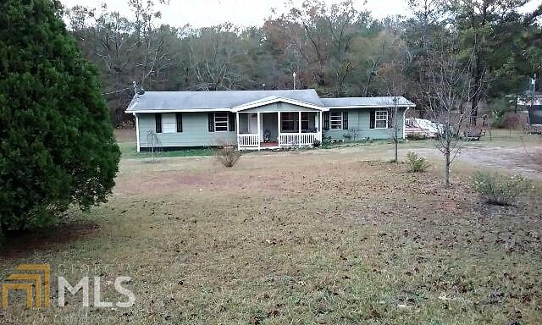 a front view of a house with yard and green space