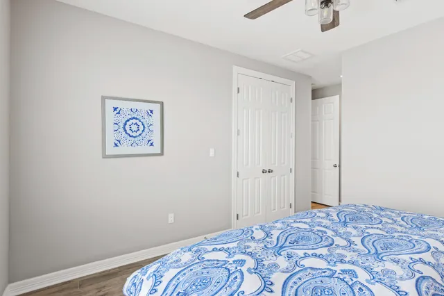 a bedroom with a bed and a painting on the wall