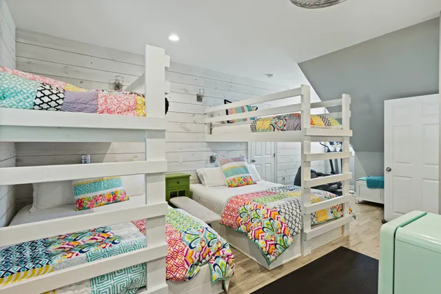 a bedroom with bed and wooden floor