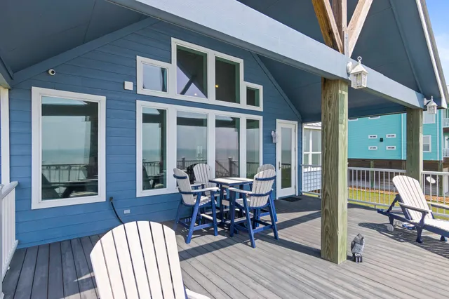 a view of a balcony with chairs and wooden floor