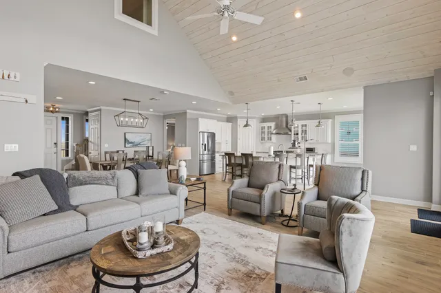 a living room with furniture and a chandelier