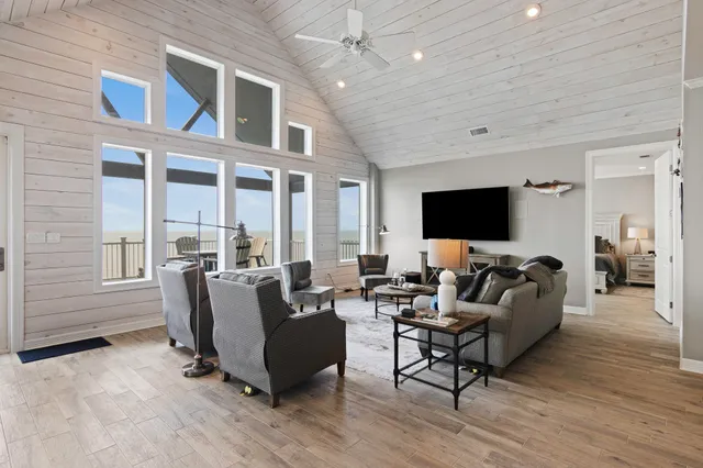 a living room with furniture wooden floor and a flat screen tv