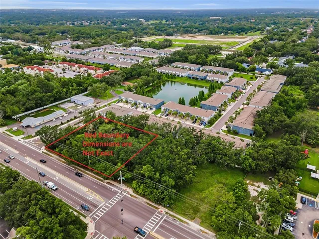 an aerial view of lake and residential houses with outdoor space