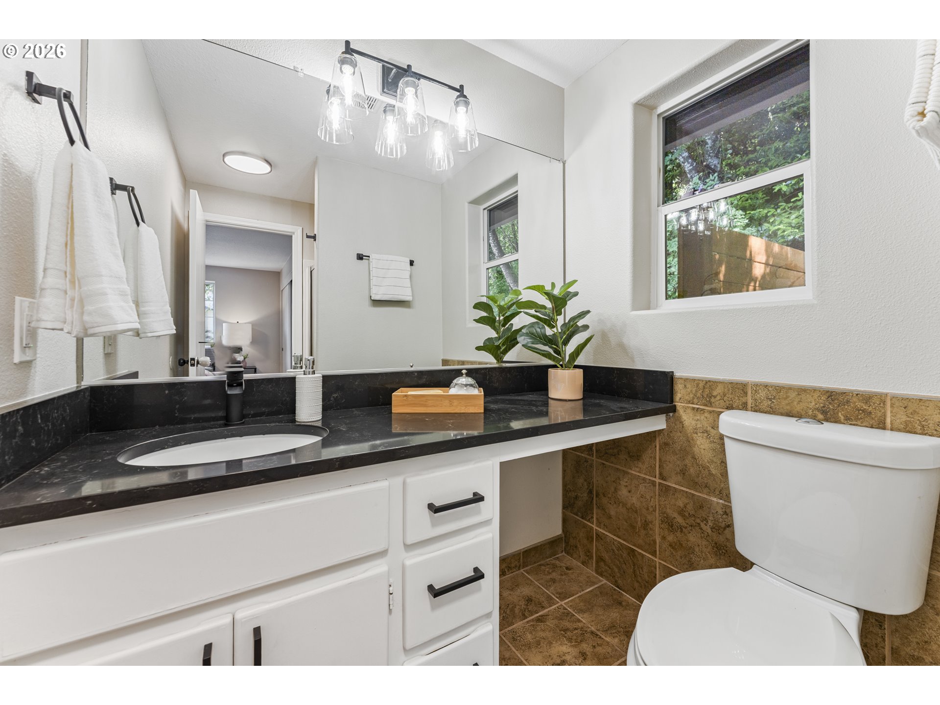 4024 Southeast 154th Place Portland, OR 97236 - Photo 14 of 43 a bathroom with a toilet a sink and a mirror