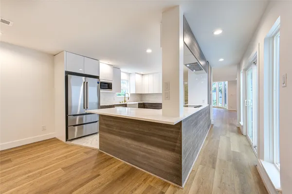 a kitchen with a stove a sink and a refrigerator
