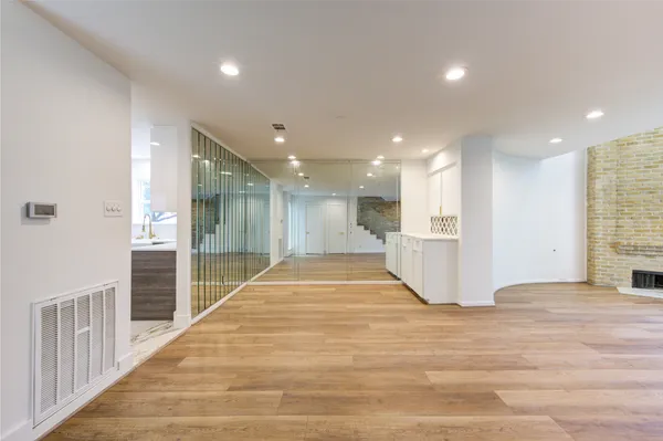 a view of an empty room with wooden floor