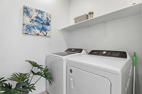 a bathroom with a sink a toilet a mirror and shower