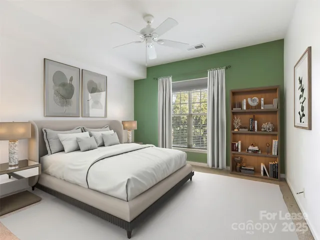 a bedroom with a large bed and a window