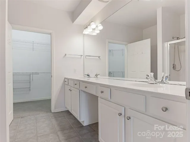 a bathroom with a double vanity sink and a mirror