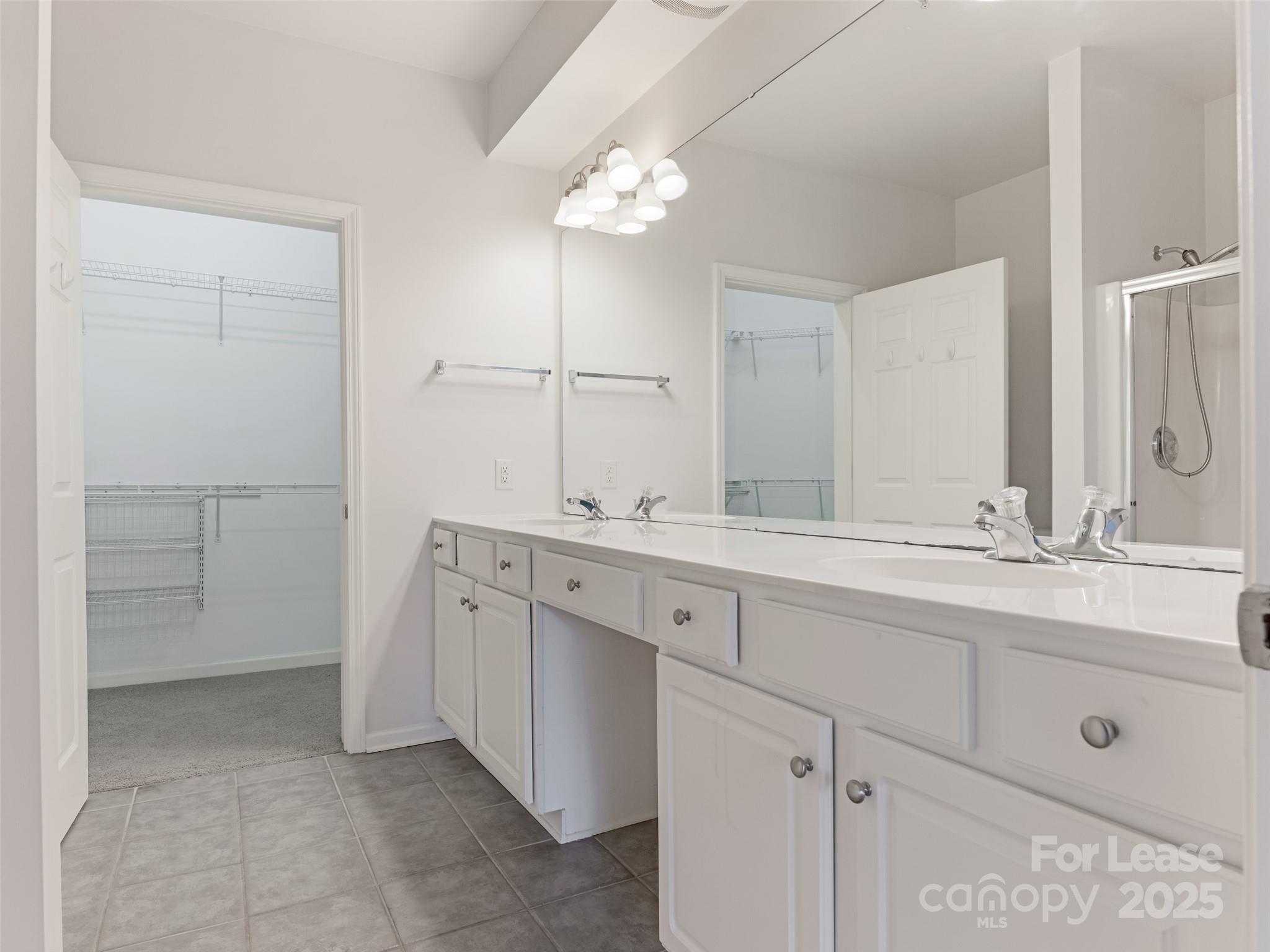3164 Margellina Drive Charlotte, NC 28210 - Photo 15 of 26 a bathroom with a double vanity sink and a mirror
