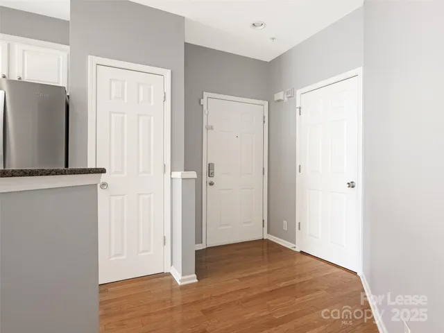 a view of a livingroom with wooden floor and a cabinet