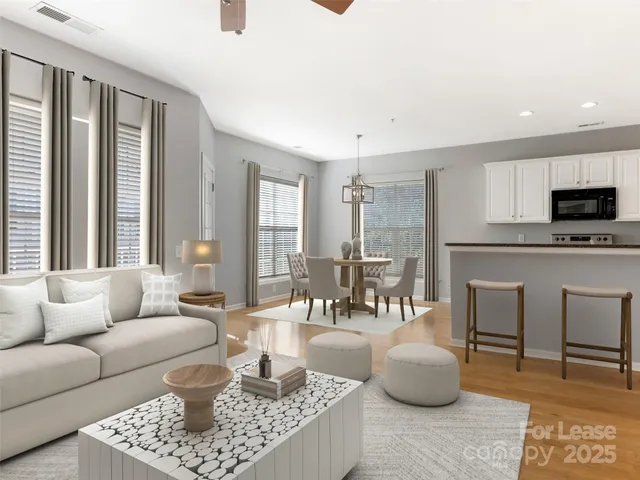 a living room with furniture a fireplace and a table