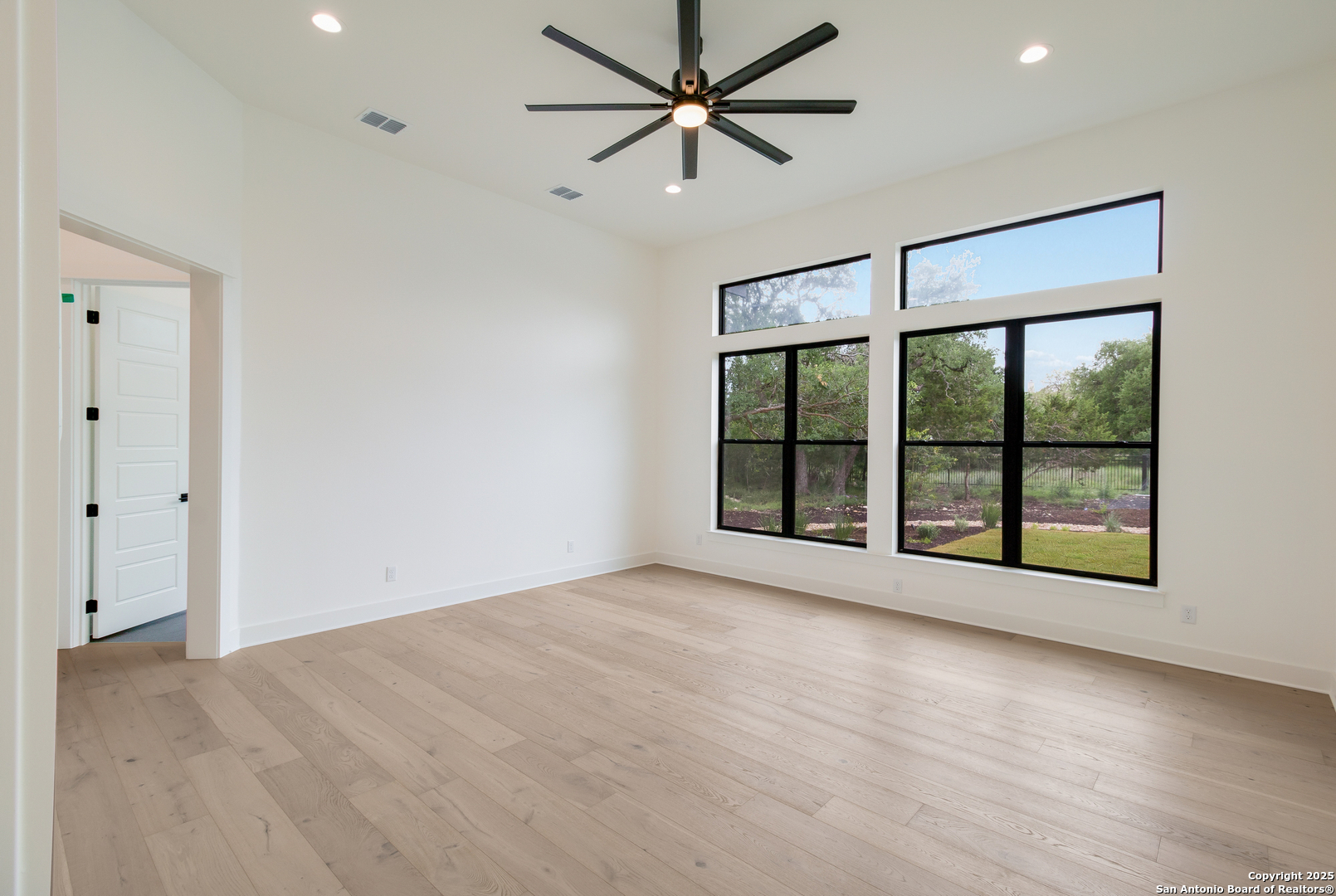 430 Arthur Court Spring Branch, TX 78070 - Photo 18 of 39 wooden floor in an empty room with a window