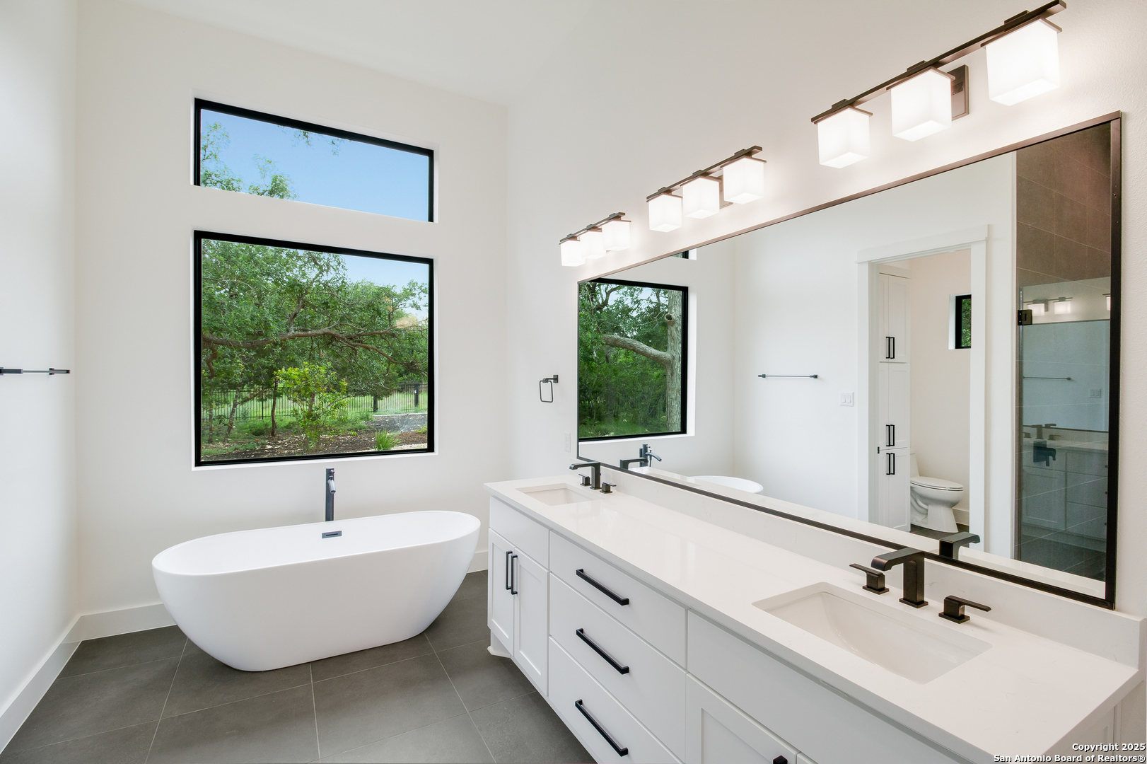 430 Arthur Court Spring Branch, TX 78070 - Photo 23 of 39 a bathroom with a double vanity sink window and a large mirror