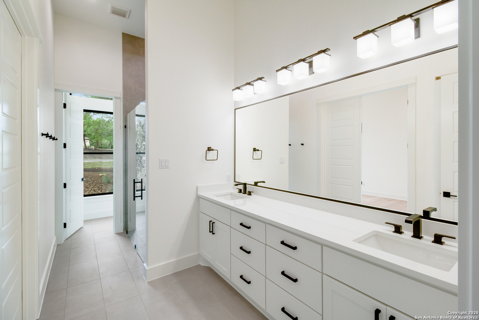 430 Arthur Court Spring Branch, TX 78070 - Photo 27 of 39 a spacious bathroom with a double vanity sink a mirror and shower