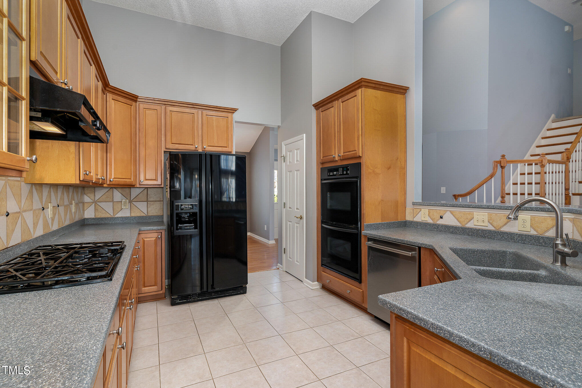 5 Coach Terrace Durham, NC 27713 - Photo 8 of 36 a kitchen with granite countertop a refrigerator and a stove top oven