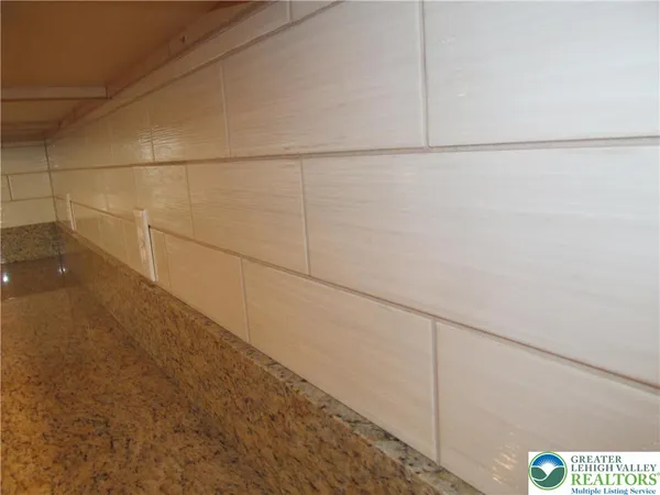 an empty room with wooden floor and mirror
