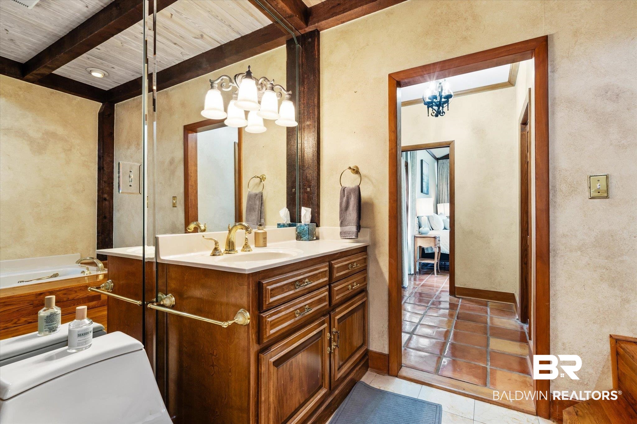 2228 Riverside Drive Mobile, AL 36605 - Photo 25 of 51 Bathroom featuring toilet, vanity, a washtub, wooden ceiling, and beam ceiling