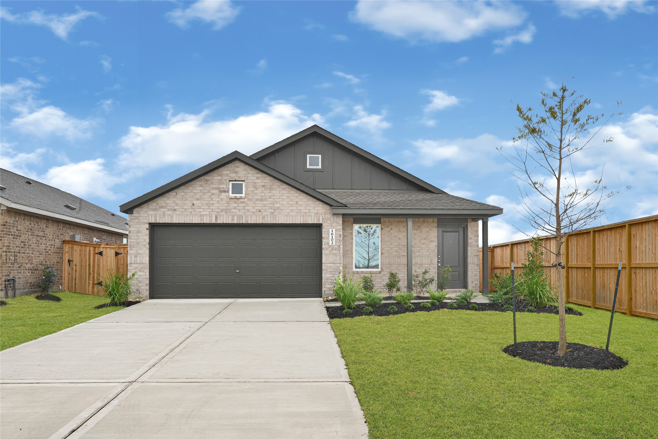 a front view of a house with a yard and garage