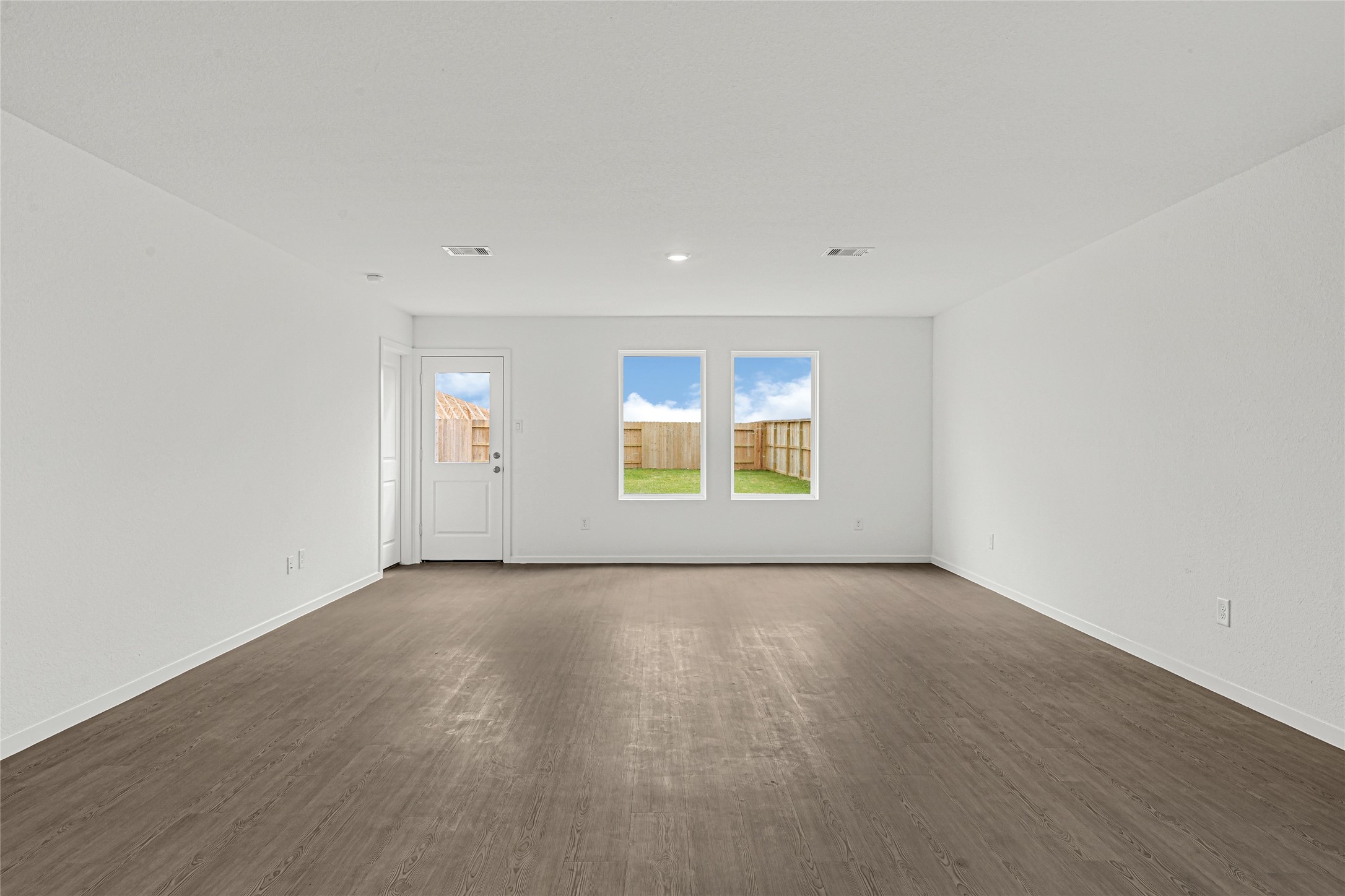 16102 Rustic Prairie Drive Hockley, TX 77447 - Photo 5 of 22 an empty room with wooden floor and windows