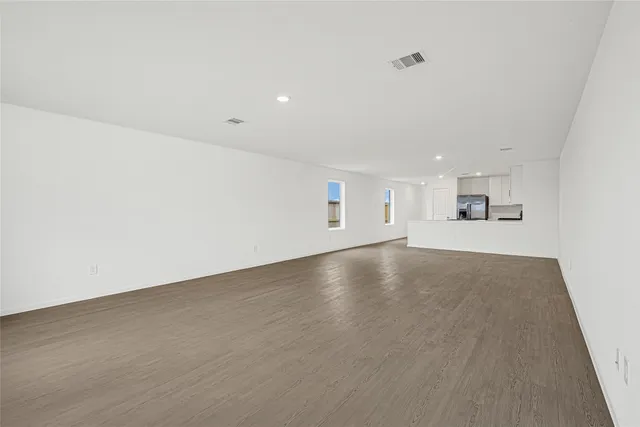 an empty room with a empty space and windows