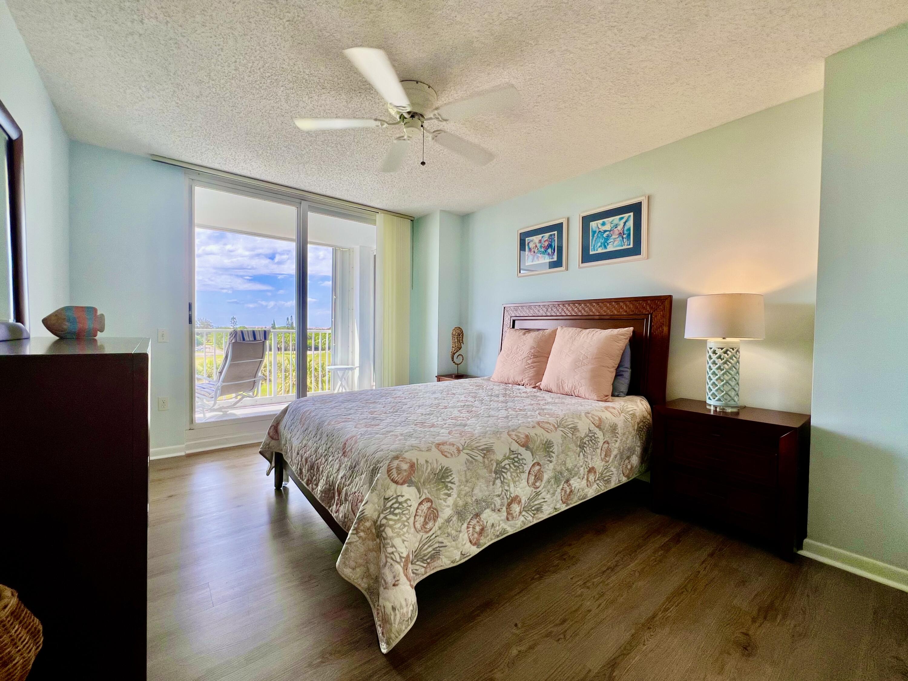 2700 North Hwy A1A, Unit 506 Fort Pierce, FL 34949 - Photo 19 of 28 a bedroom with a bed and wooden floor