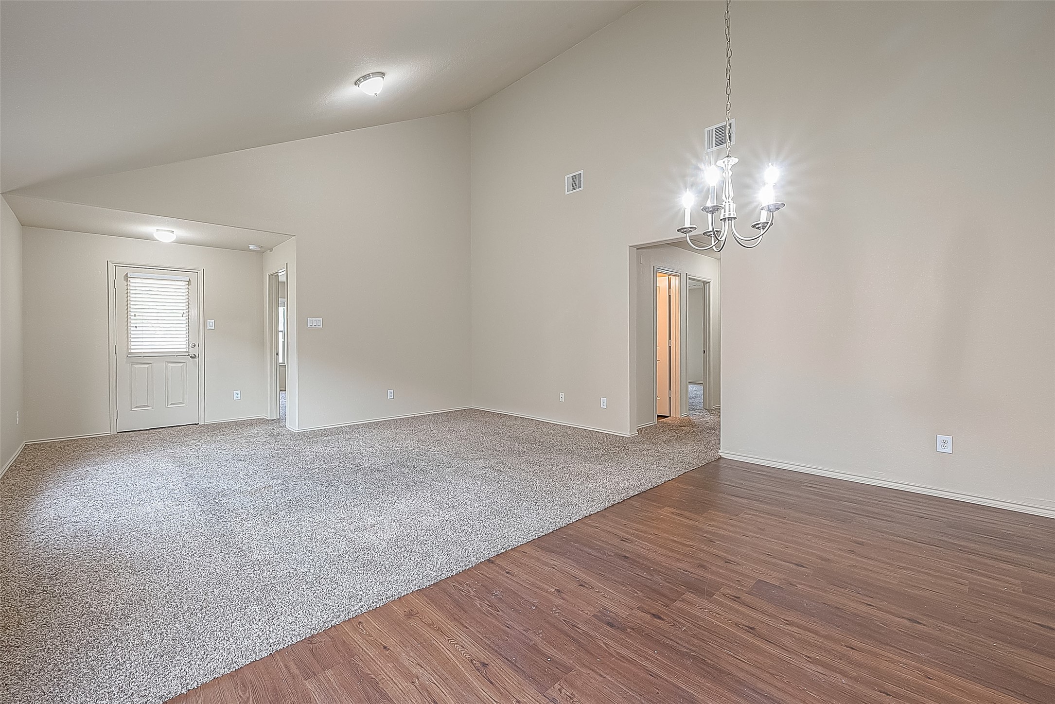 2038 Treasure Mountain Drive Spring, TX 77388 - Photo 14 of 45 an empty room with wooden floor and chandelier