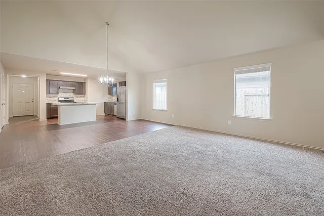 a large kitchen with granite countertop a sink and cabinets