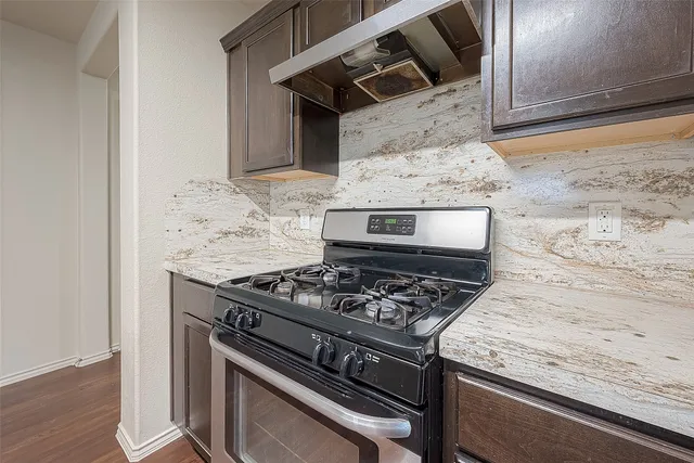 a kitchen with a sink and wooden floor