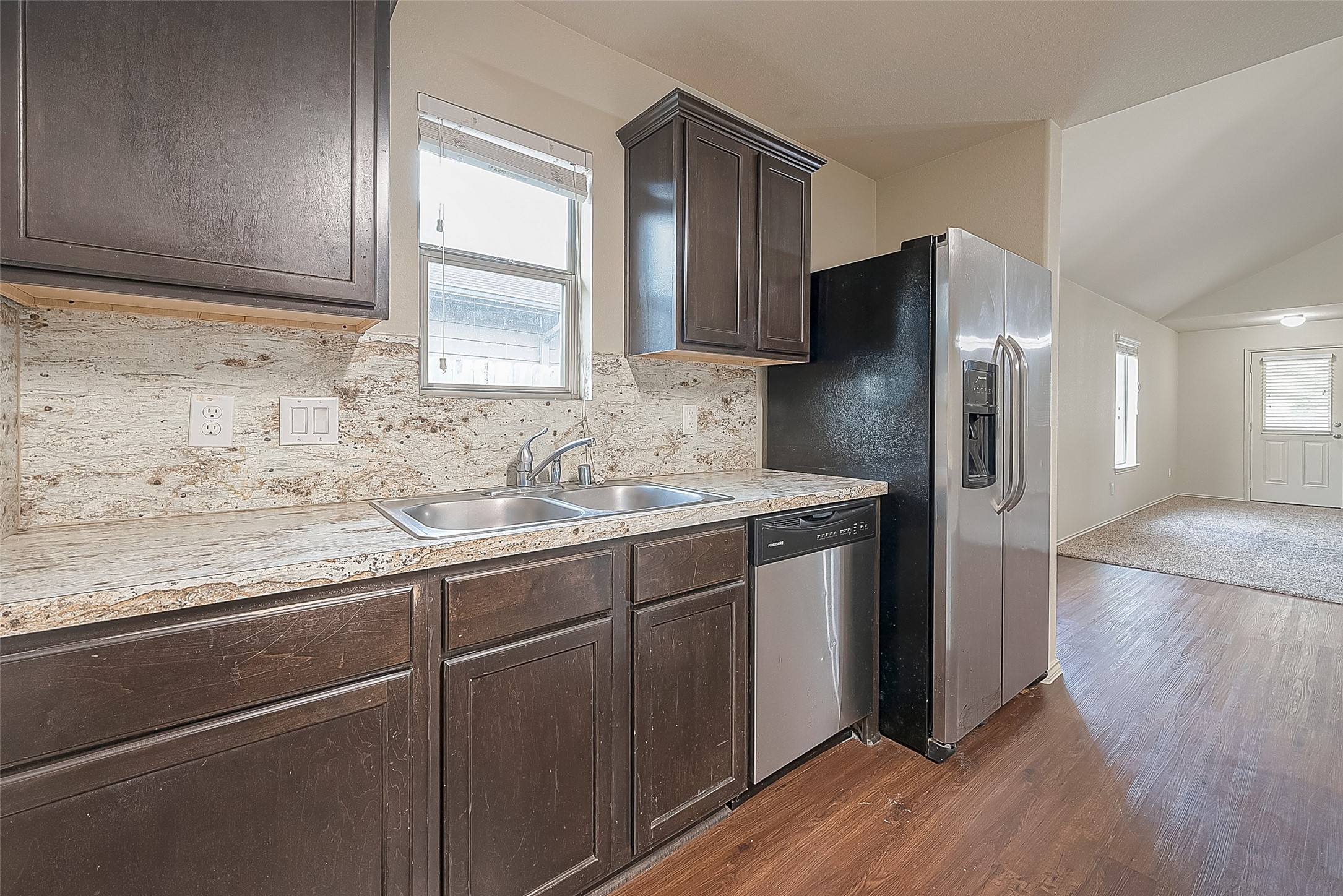 2038 Treasure Mountain Drive Spring, TX 77388 - Photo 23 of 45 a kitchen with stainless steel appliances granite countertop a refrigerator a sink and wooden cabinets