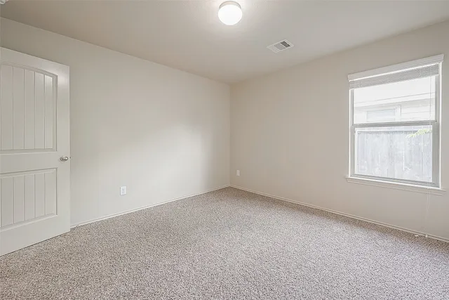 a view of an empty room and closet area
