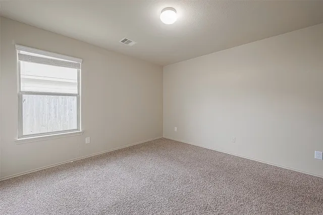 a view of an empty room and a window
