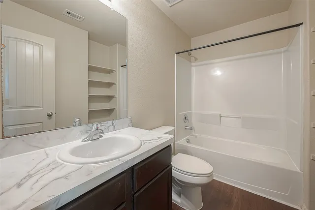 a bathroom with a bathtub and a toilet