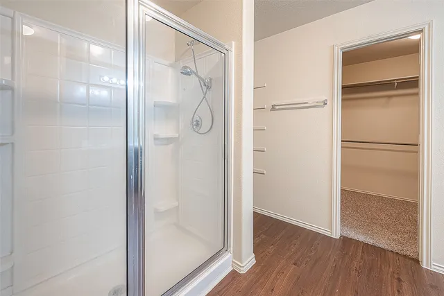 a bathroom with a glass shower door