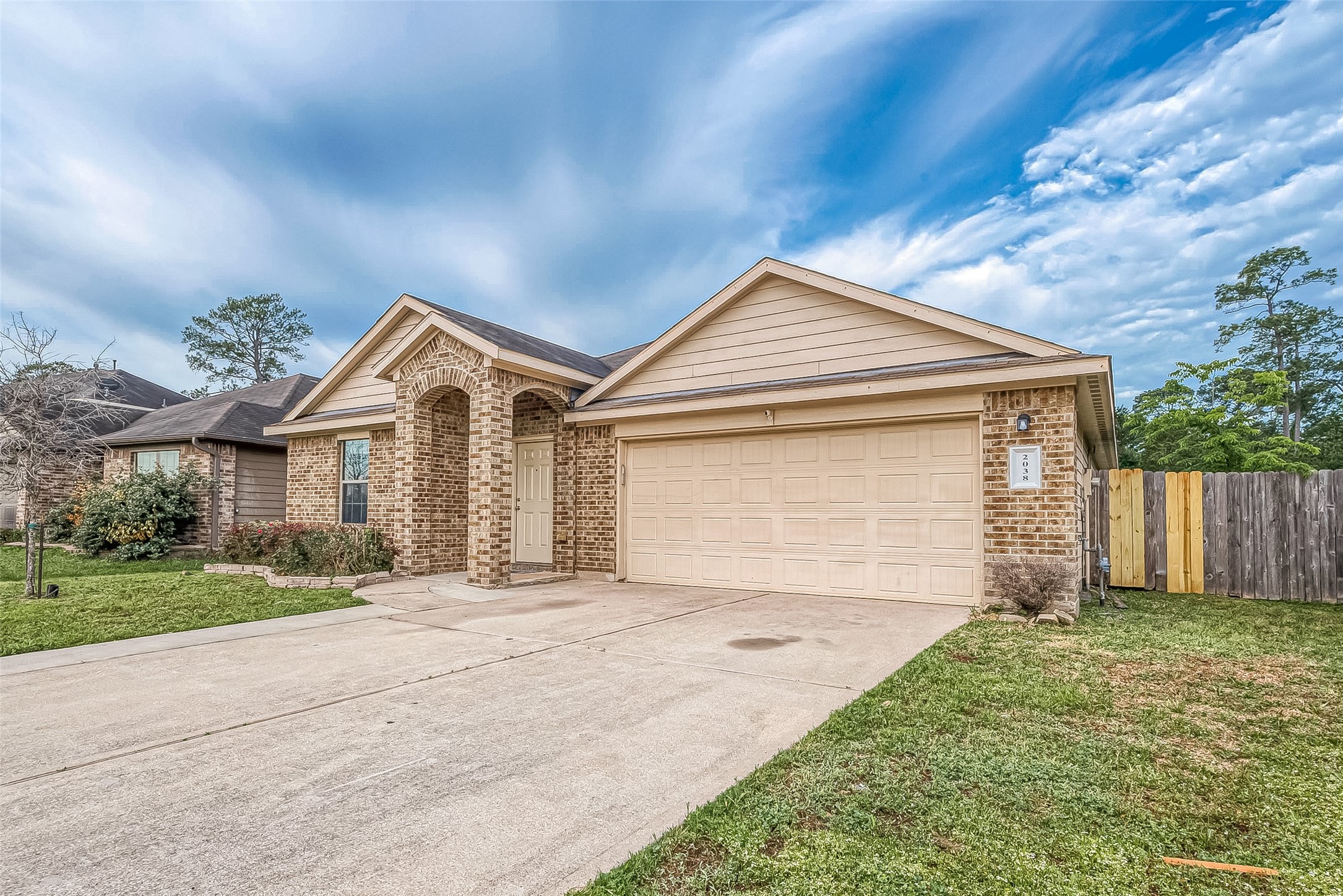 2038 Treasure Mountain Drive Spring, TX 77388 - Photo 4 of 45 a front view of a house with a yard and garage