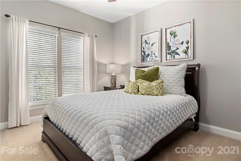 1933 Faison Avenue, Unit 69 Fort Mill, SC 29708 - Photo 15 of 40 a large bed sitting in a bedroom next to a window