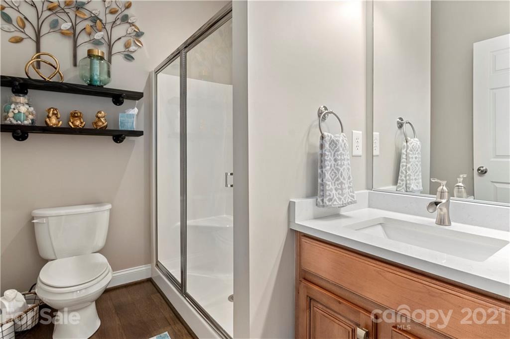 1933 Faison Avenue, Unit 69 Fort Mill, SC 29708 - Photo 16 of 40 a bathroom with a toilet sink and mirror