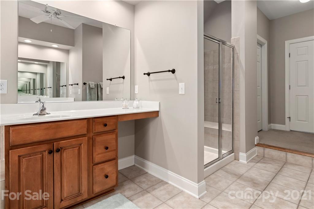 1933 Faison Avenue, Unit 69 Fort Mill, SC 29708 - Photo 19 of 40 a spacious bathroom with a shower sink and mirror