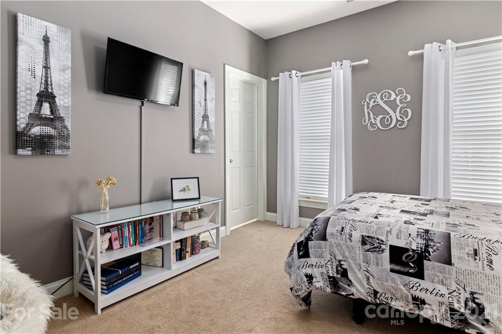 1933 Faison Avenue, Unit 69 Fort Mill, SC 29708 - Photo 21 of 40 a bedroom with furniture and a flat screen tv