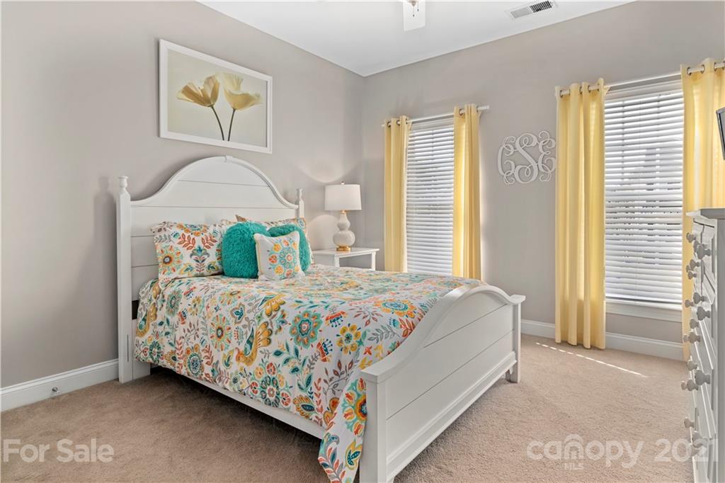 1933 Faison Avenue, Unit 69 Fort Mill, SC 29708 - Photo 23 of 40 a bedroom with a bed and painting on the wall