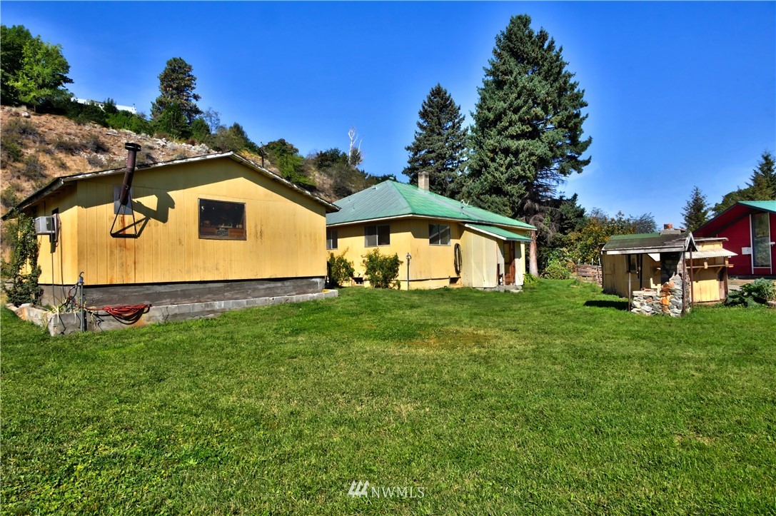 628 Twisp Carlton Road Twisp, WA 98856 - Photo 2 of 32 a view of a backyard with table and chairs and potted plants