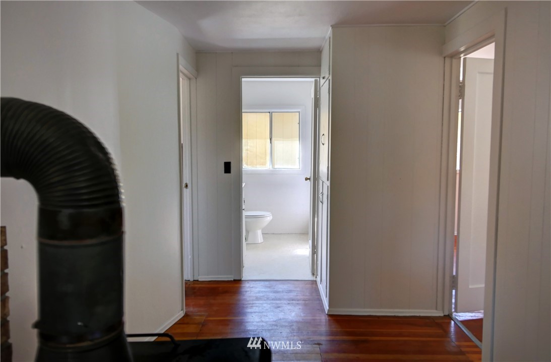 628 Twisp Carlton Road Twisp, WA 98856 - Photo 12 of 32 a view of a hallway with wooden floor
