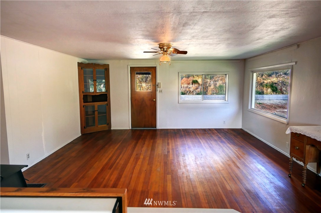 628 Twisp Carlton Road Twisp, WA 98856 - Photo 29 of 32 wooden floor in an empty room with a window