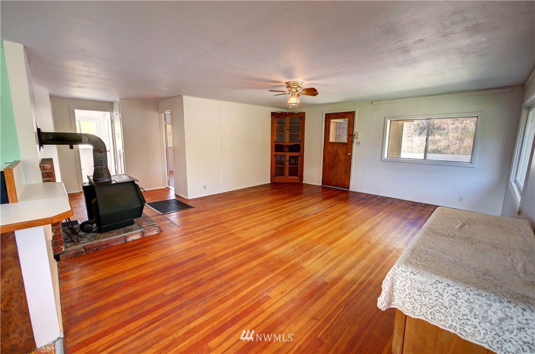 628 Twisp Carlton Road Twisp, WA 98856 - Photo 30 of 32 a view of a livingroom with hardwood floor and a ceiling fan