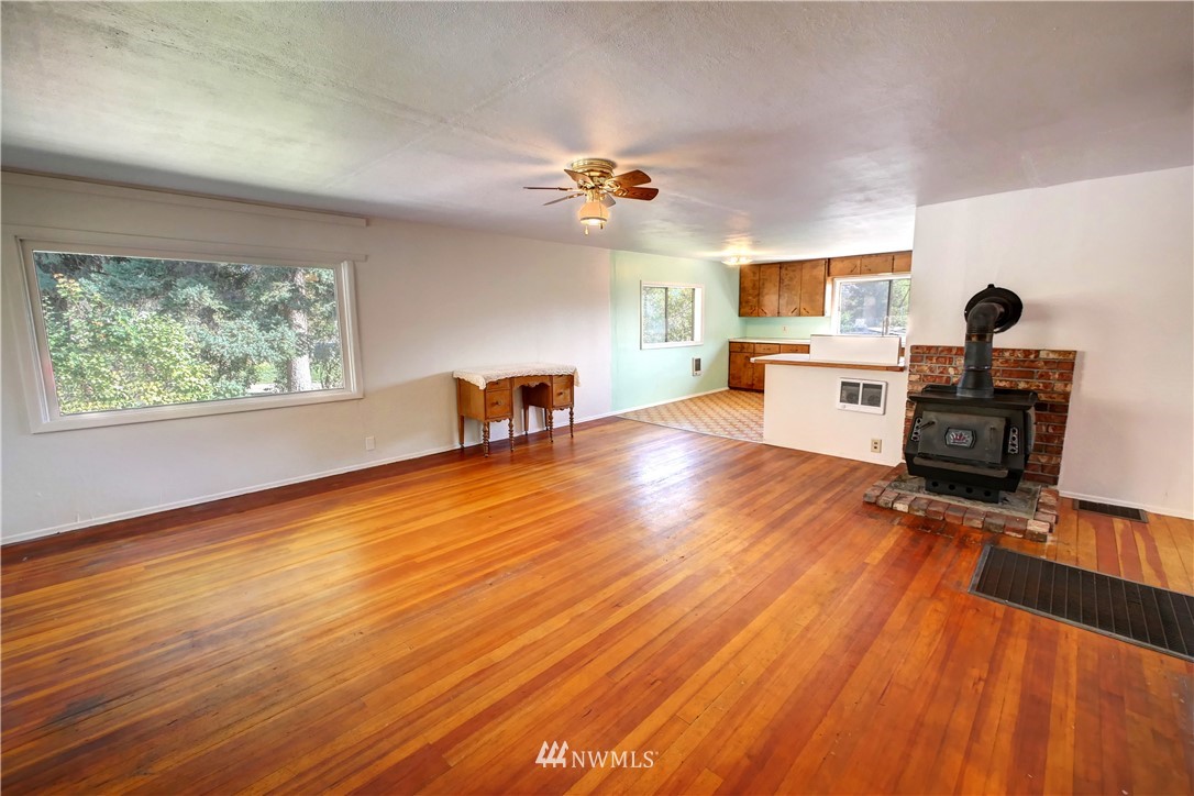 628 Twisp Carlton Road Twisp, WA 98856 - Photo 4 of 32 a view of a livingroom with furniture a ceiling fan and wooden floor